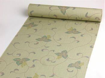 A tsumugi kimono woven in Tango, featuring an arabesque pattern in green
