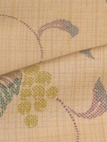A tsumugi kimono woven in Tango, featuring an arabesque pattern in orange